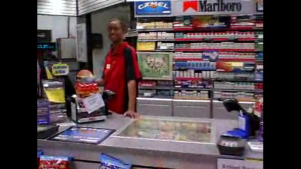 A dark-hued female working in a store